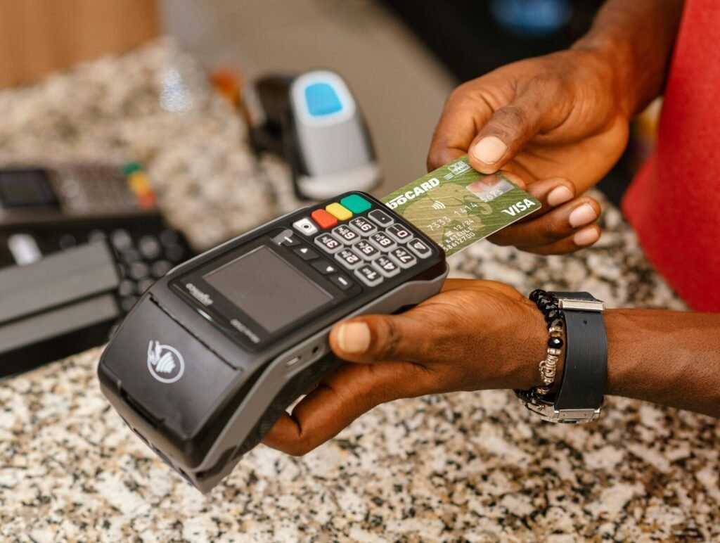 a person holding a credit card in their hand
